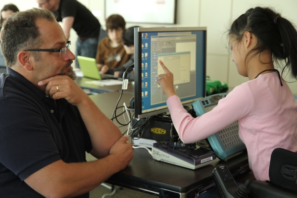 A deaf-blind student working alongside her interpreter